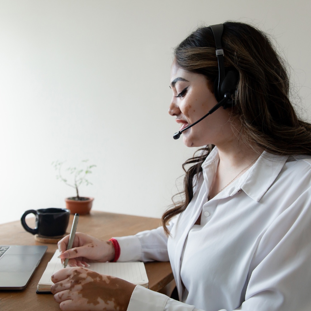 Remote Sales Specialist documenting a prospect conversation while wearing a headset